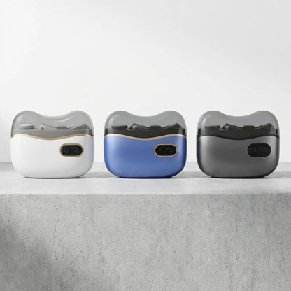 Josh & Tate - NailPod™ Automatic Nail Care System - Three electronic devices with different color options on a gray surface.
