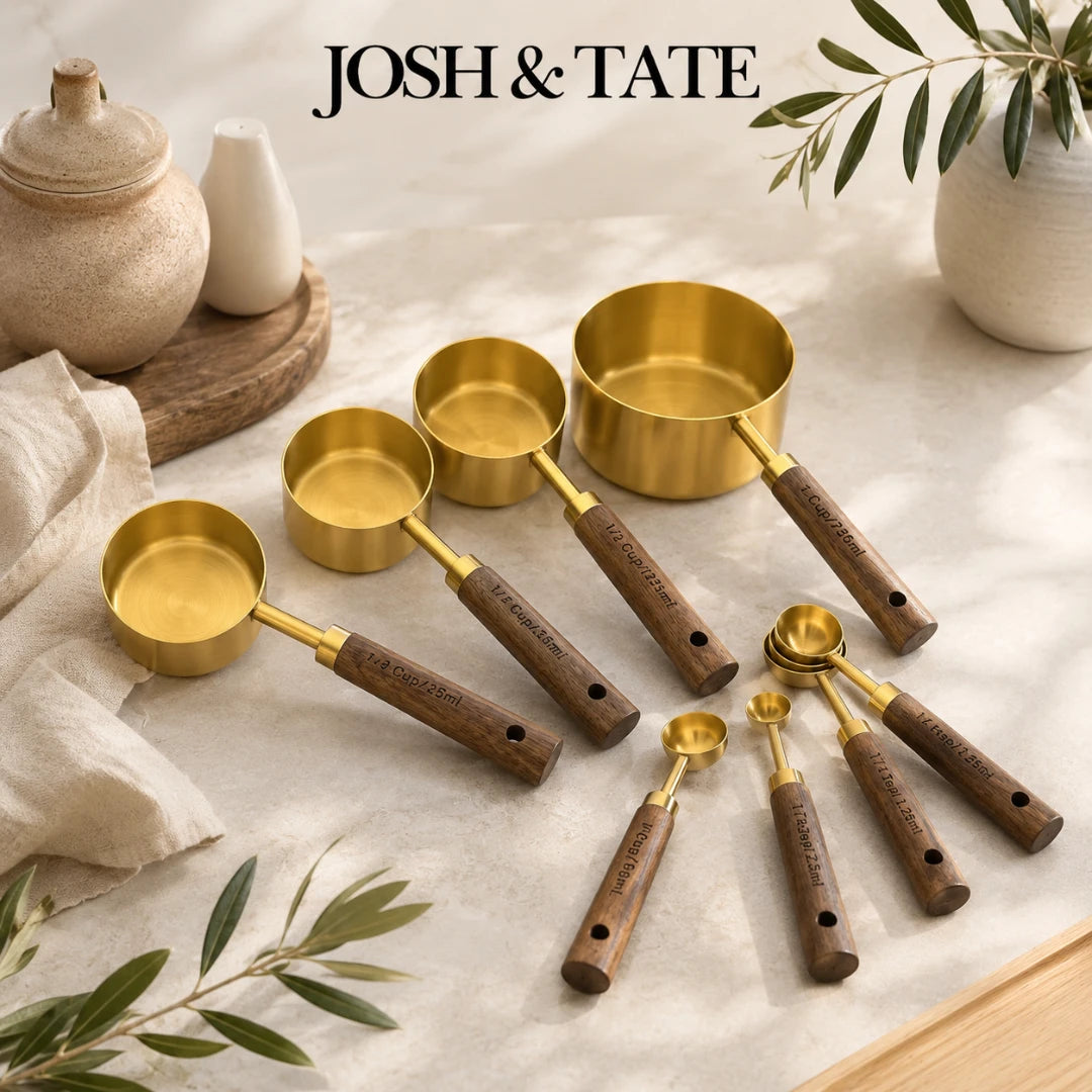 Josh & Tate - Natural Wood Measuring Cup Spoon Set - Set of gold measuring cups and spoons with wooden handles on a light surface, featuring the brand 'Josh & Tate'.