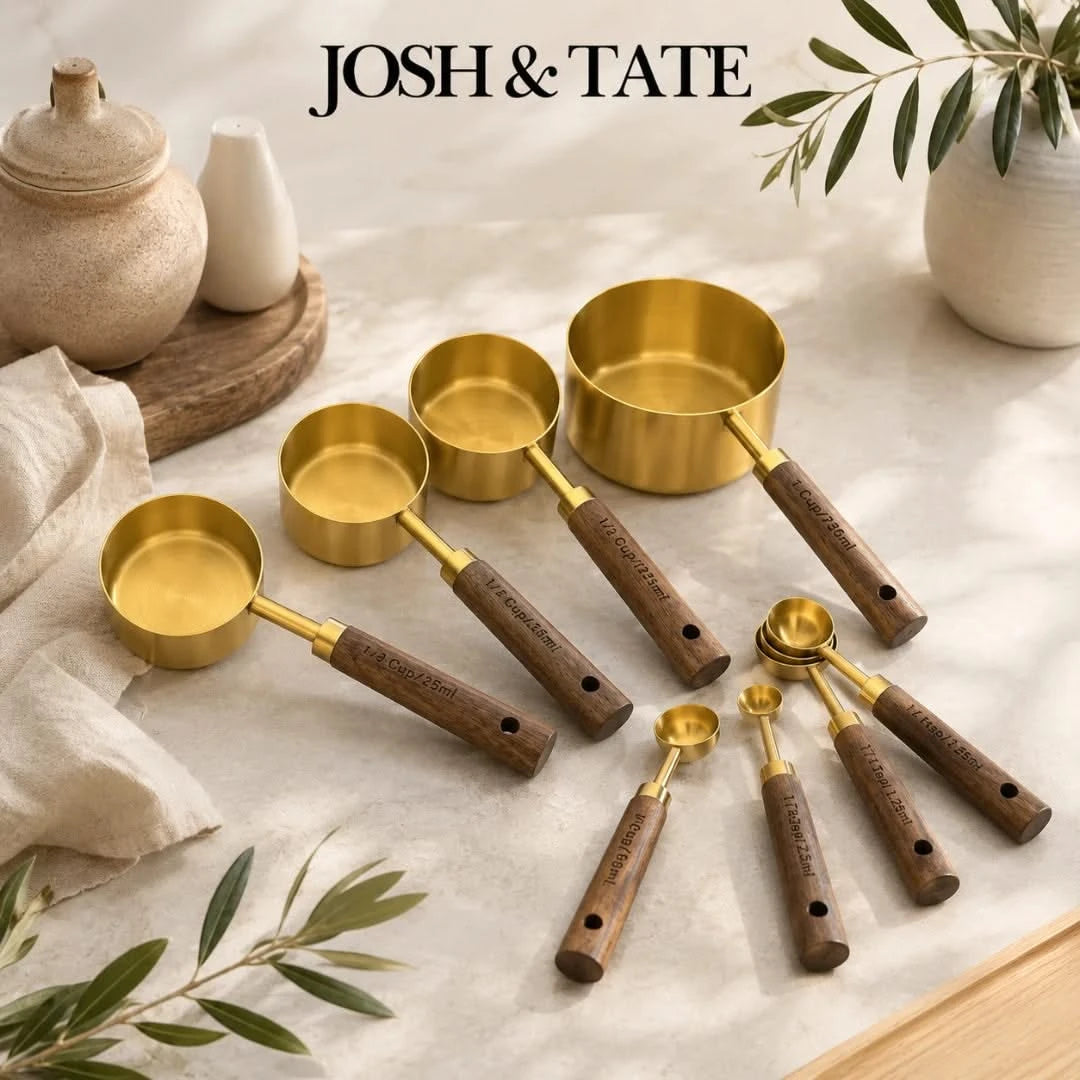 Josh & Tate - Natural Wood Measuring Cup Spoon Set - Set of gold measuring cups and spoons with wooden handles on a light surface, featuring the brand 'Josh & Tate'.