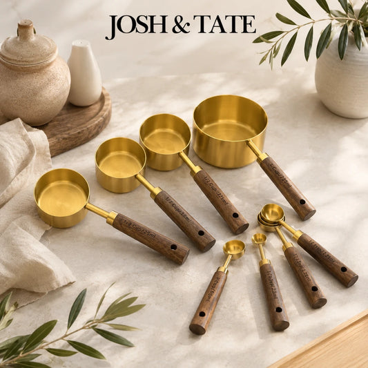 Josh & Tate - Natural Wood Measuring Cup Spoon Set - Set of gold measuring cups and spoons with wooden handles on a light surface, featuring the brand 'Josh & Tate'.