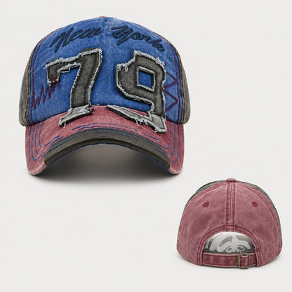 Josh & Tate - NewYork79™ Vintage Cap - A distressed baseball cap shown from the front and back on a light gray background. The front features a blue denim-like crown with 'New York' embroidered in black script and large '79' patchwork numbers outlined in silver.