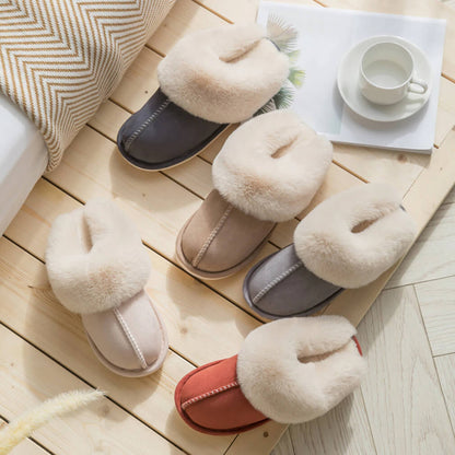 Pair of fluffy slippers on a wooden floor with a cup and saucer in the background.