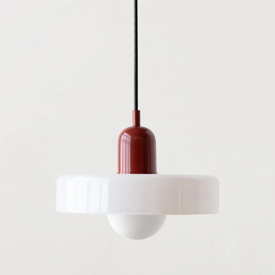 Pendant light with a white shade and red-brown fixture on a plain background