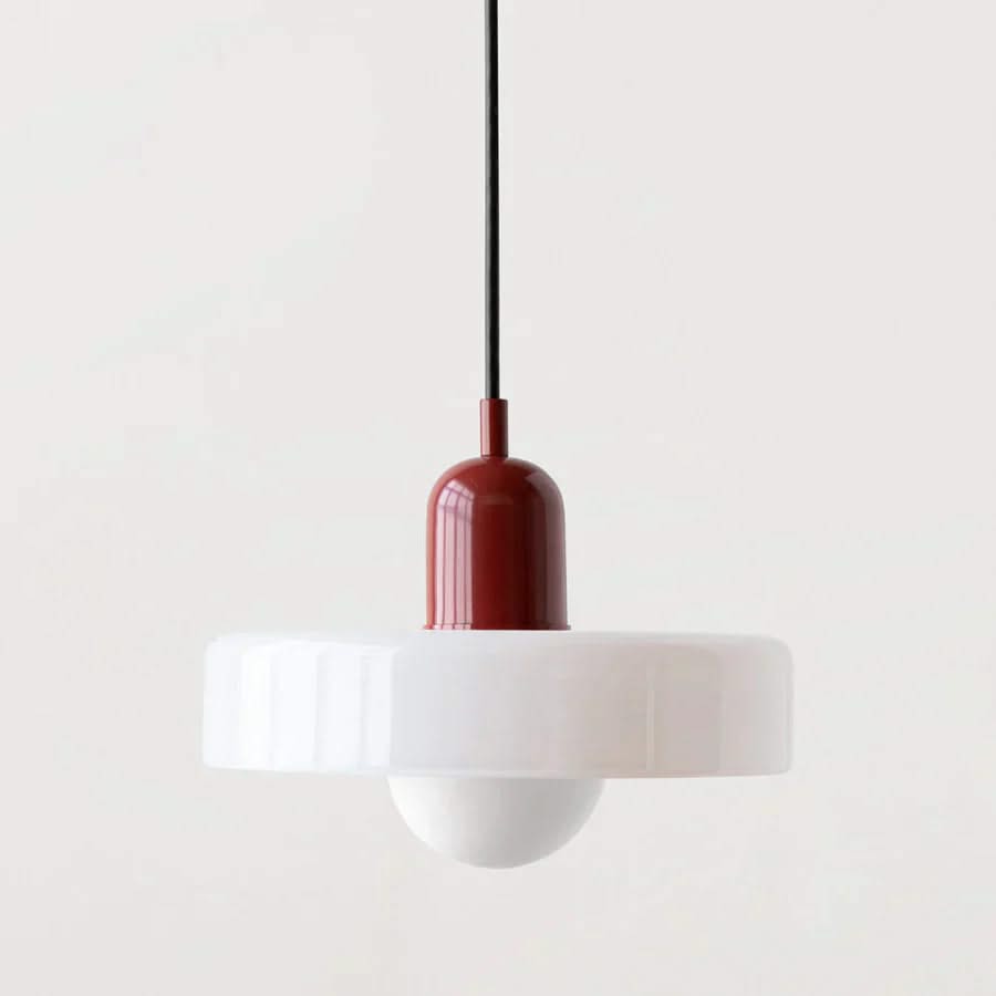 Pendant light with a white shade and red-brown fixture on a plain background