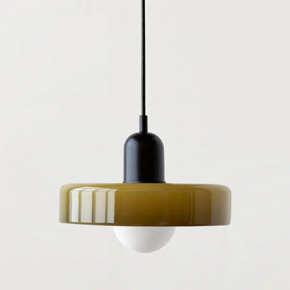Pendant light with a mustard yellow shade and black fixture on a white background