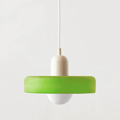 Green pendant light with a white bulb on a plain background