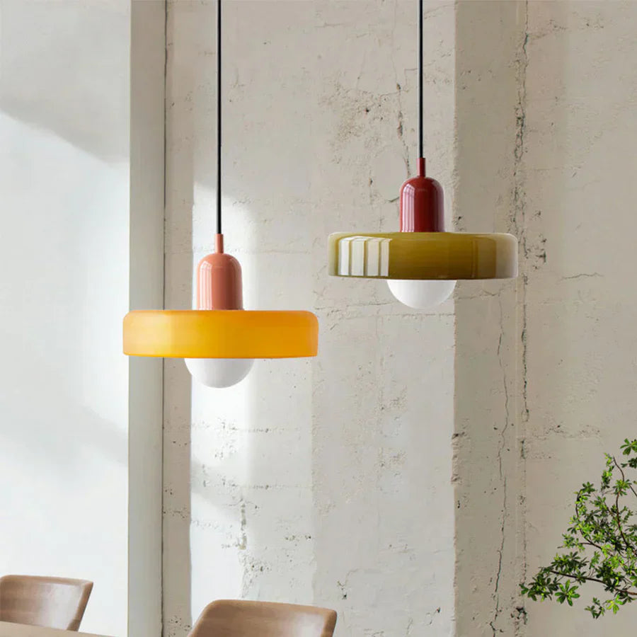 Two pendant lights hanging from the ceiling with a neutral background