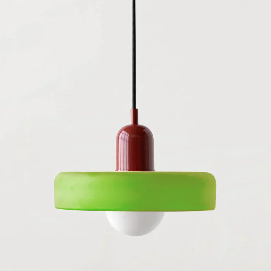 Pendant light with green base and red top on a white background