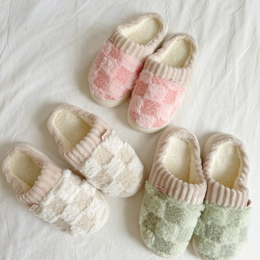 Pair of pink and white checkered slippers on a white background