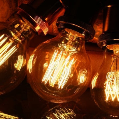 Vintage-style light bulbs with visible filaments on a dark background