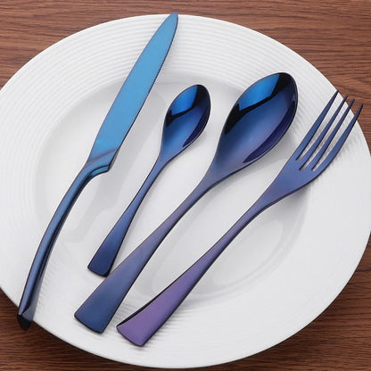 Set of blue cutlery on a white plate with a wooden background