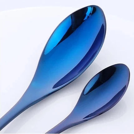 Two blue reflective spoons on a white background