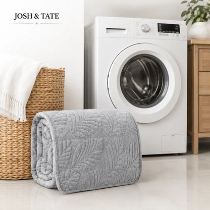 Josh & Tate - PalmSoft™ Quilted Chair Cover - Gray quilted blanket in front of a washing machine with 'Josh & Tate' branding.