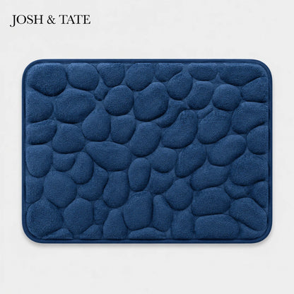 Josh & Tate - PebbleSoft™ Non-Slip Memory Foam Mat - Blue textured bath mat with 'JOSH & TATE' branding on a light gray background