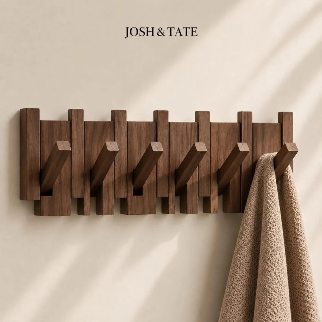 Josh & Tate - PianoHook™ Solid Wood Wall Rack - Wooden wall hook with multiple hooks on a beige wall, featuring the brand 'Josh & Tate'.