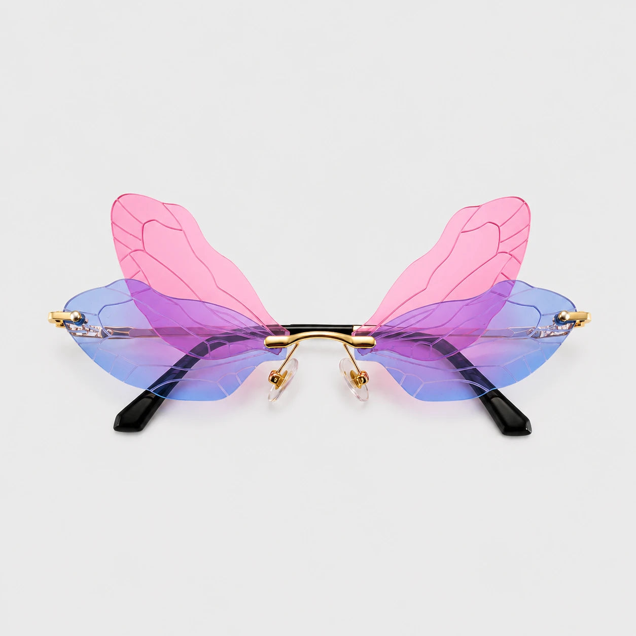 Josh & Tate - PixieFrame™ Butterfly Sunglasses - Unusual butterfly-wing style eyeglasses with translucent pink and blue wings, gold metal hinges, and black temple tips, shown on a light gray background.