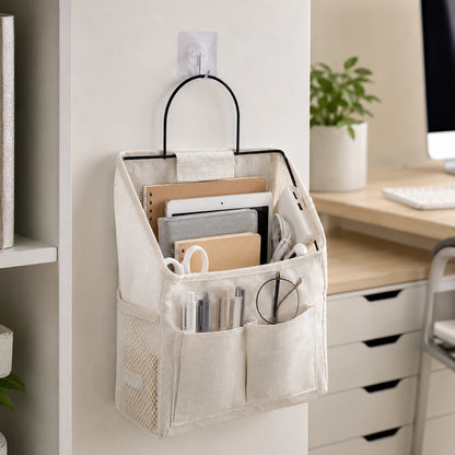 Josh & Tate - PocketPerch™ Hanging Organizer - A beige fabric hanging organizer with a black metal handle, mounted on a wall in a home office setting. The organizer contains various office supplies, including notebooks, pens, and glasses, and is shown in a clean, modern workspace environment.