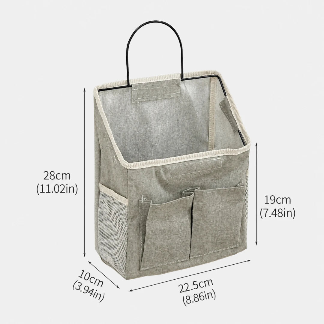 Josh & Tate - PocketPerch™ Hanging Organizer - A light gray fabric hanging organizer basket with a black metal handle, shown with dimension labels and measurement lines indicating height, width, and depth on a plain light background.