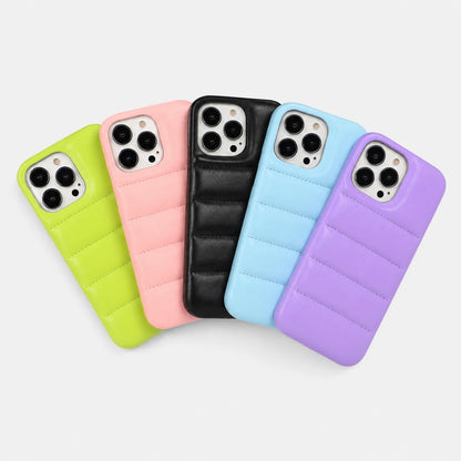Five phone cases in green, pink, black, blue, and purple on a light gray background