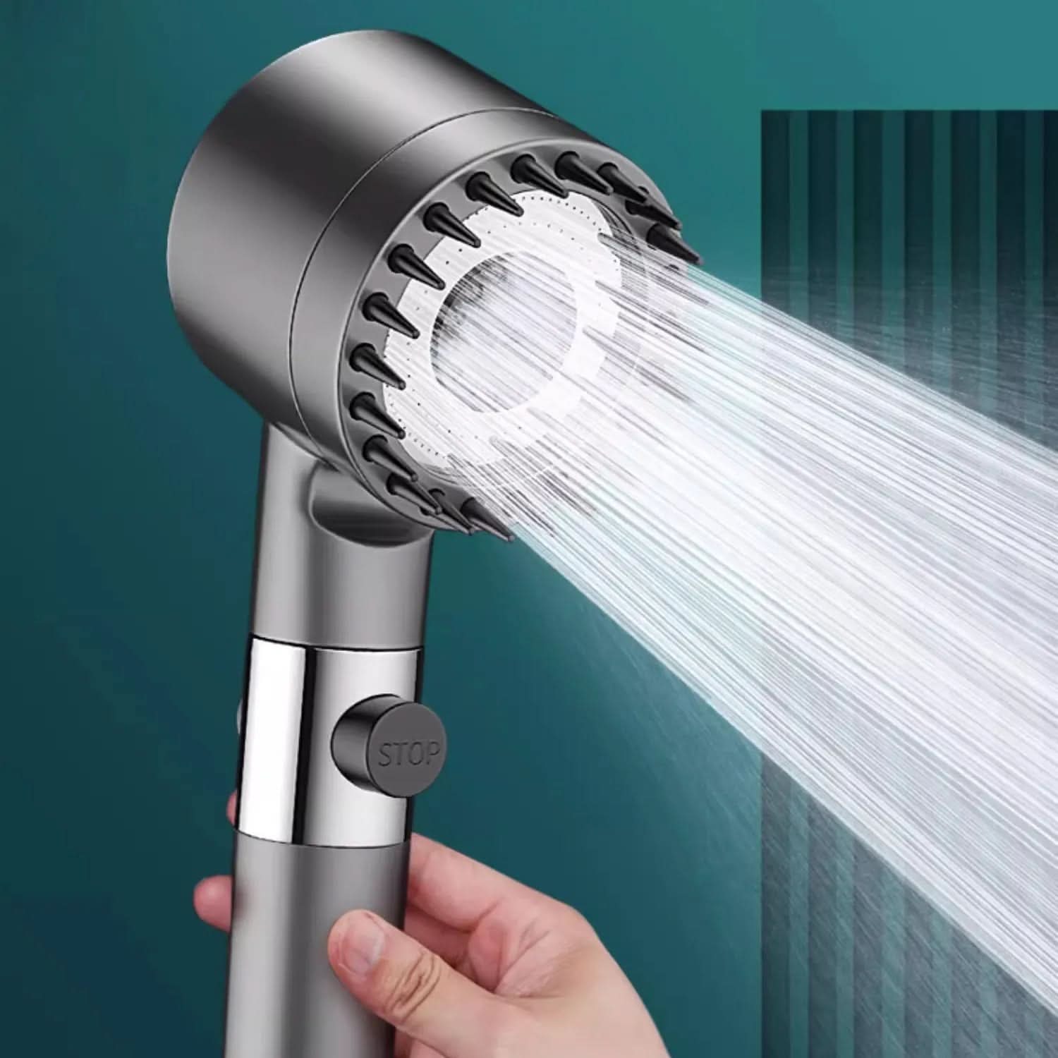 Handheld shower head with water flowing against a teal background