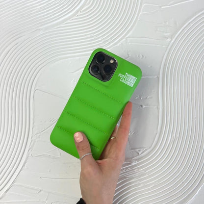 Green phone case held by a hand on a white textured background