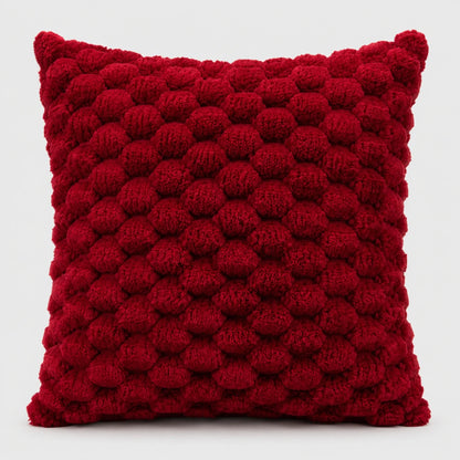 Josh & Tate - PuffKnot™ Bobble Cushion Cover - A square red throw pillow with a textured, raised pom-pom or bumpy knit pattern, shown against a plain light gray background.