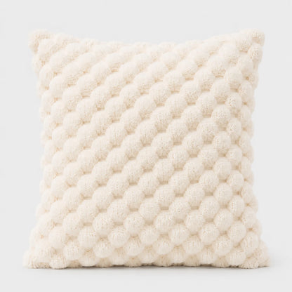 Josh & Tate - PuffKnot™ Bobble Cushion Cover - A square cream-colored throw pillow with a textured, raised pom-pom or bumpy knit pattern, shown against a plain light gray background.