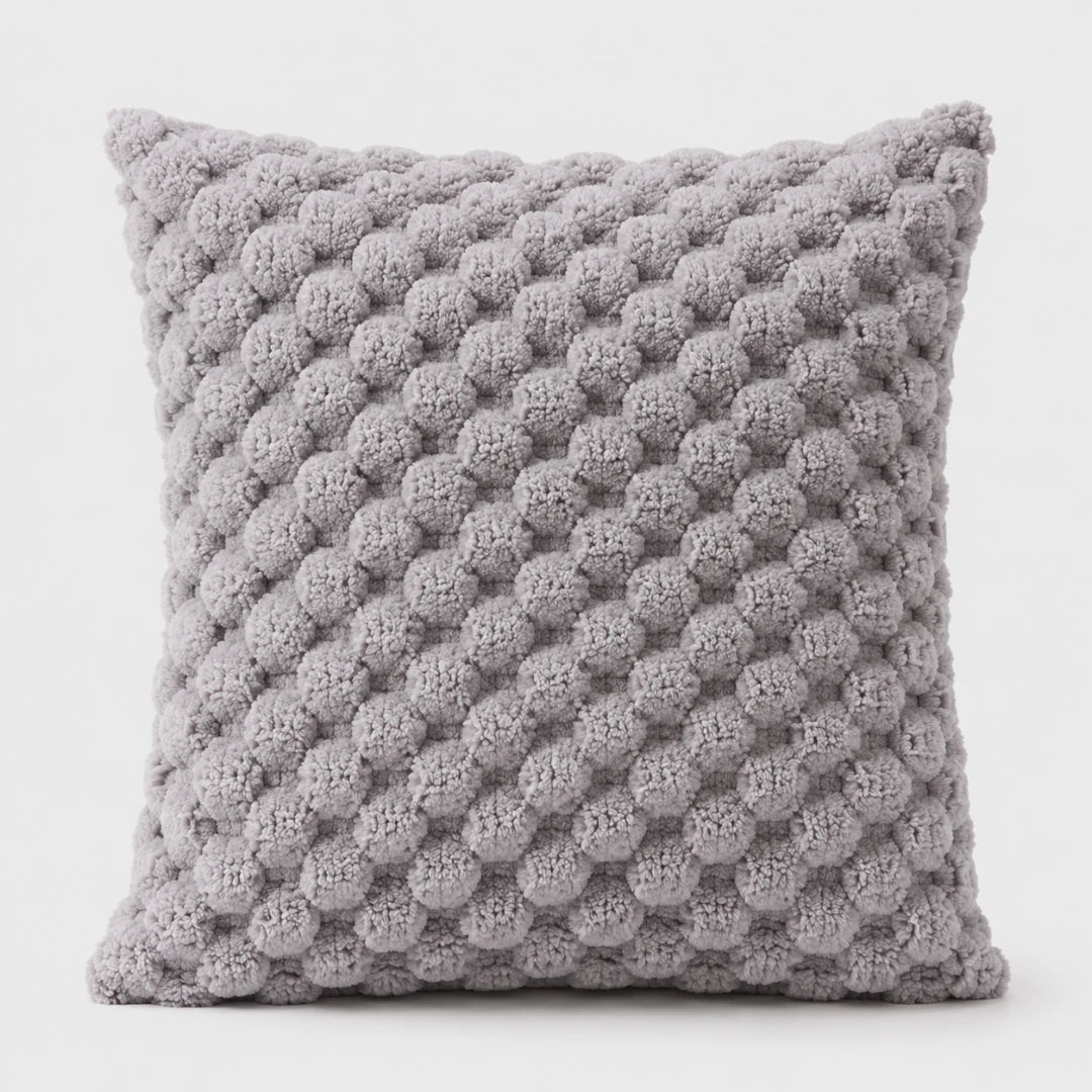 Josh & Tate - PuffKnot™ Bobble Cushion Cover - A square throw pillow in a textured, chunky knit fabric with a light gray and white honeycomb pattern, shown against a plain white background.