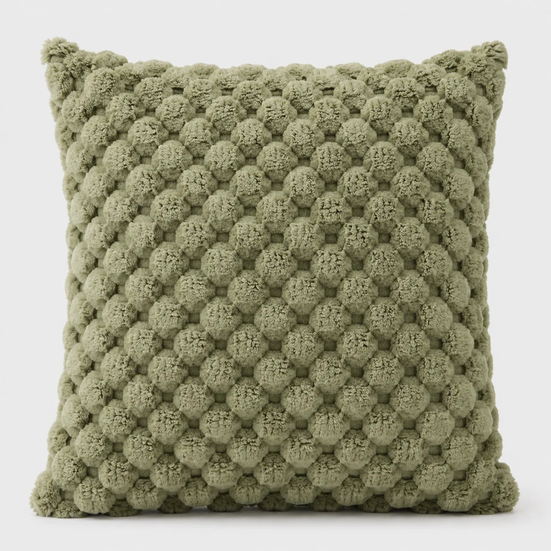 Josh & Tate - PuffKnot™ Bobble Cushion Cover - An olive green textured throw pillow with a raised, bumpy pom-pom style pattern, shown against a plain light gray background.