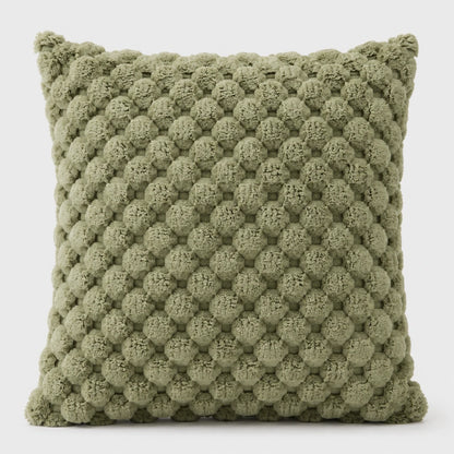 Josh & Tate - PuffKnot™ Bobble Cushion Cover - An olive green textured throw pillow with a raised, bumpy pom-pom style pattern, shown against a plain light gray background.