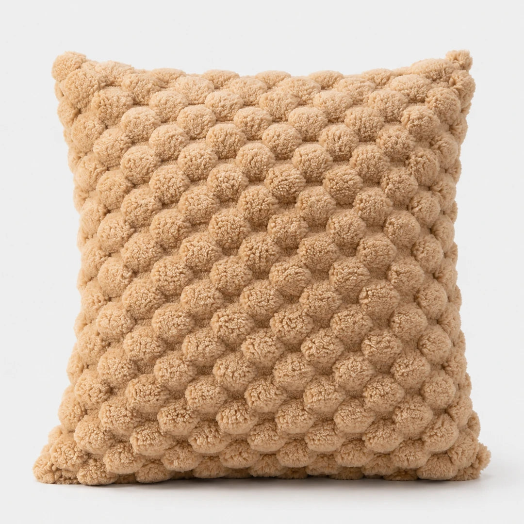 Josh & Tate - PuffKnot™ Bobble Cushion Cover - A square throw pillow in a warm camel beige color, featuring a textured, raised bumpy pattern, shown against a plain white background.