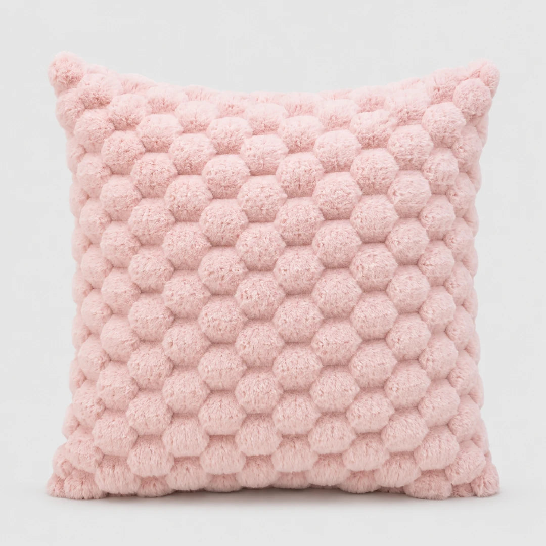 Josh & Tate - PuffKnot™ Bobble Cushion Cover - A square pink throw pillow with a textured honeycomb pom-pom pattern, shown against a plain light gray background.