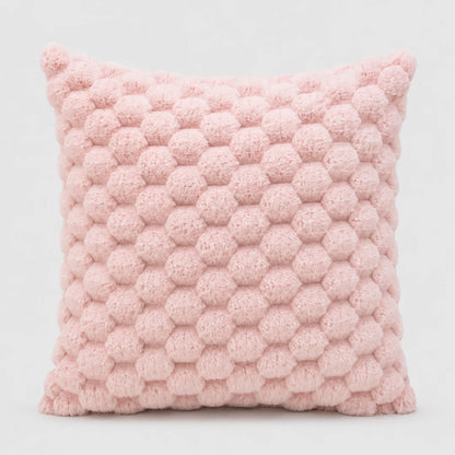 Josh & Tate - PuffKnot™ Bobble Cushion Cover - A square pink throw pillow with a textured honeycomb pom-pom pattern, shown against a plain light gray background.