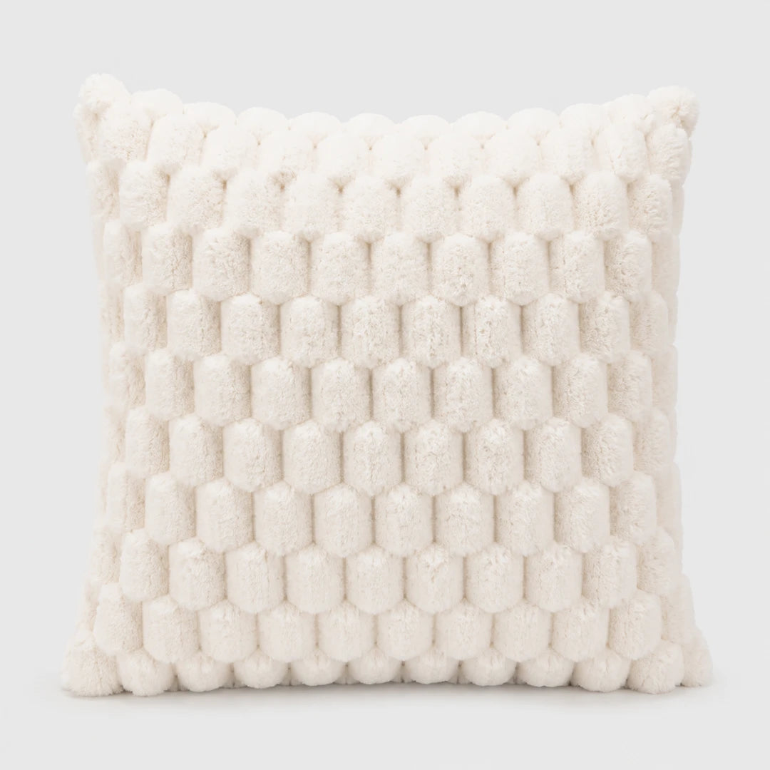 Josh & Tate - PuffKnot™ Bobble Cushion Cover - A square throw pillow in a warm off-white or cream bouclé fabric, featuring a raised honeycomb or bumpy textured pattern, shown against a light gray studio background.