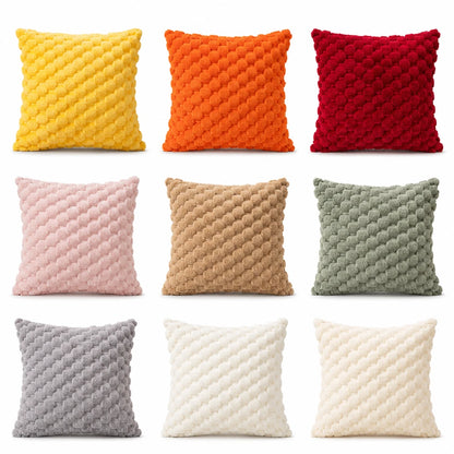Josh & Tate - PuffKnot™ Bobble Cushion Cover - Nine square throw pillows arranged in a 3-by-3 grid on a white background, each in a different color: yellow, orange, red, pink, tan, sage green, gray, off-white, and cream. The pillows have a chunky, textured bobble or chenille surface.