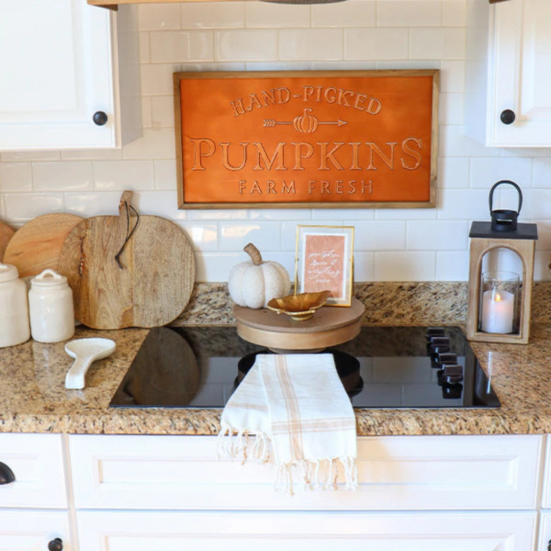 Josh & Tate - Pumpkin Wooden Cutting Board - Kitchen counter with decorative items including a pumpkin, lantern, and 'Hand-Picked Pumpkins Farm Fresh' sign.