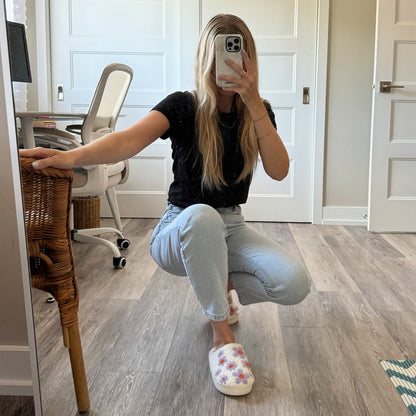Person taking a mirror selfie in a home office setting