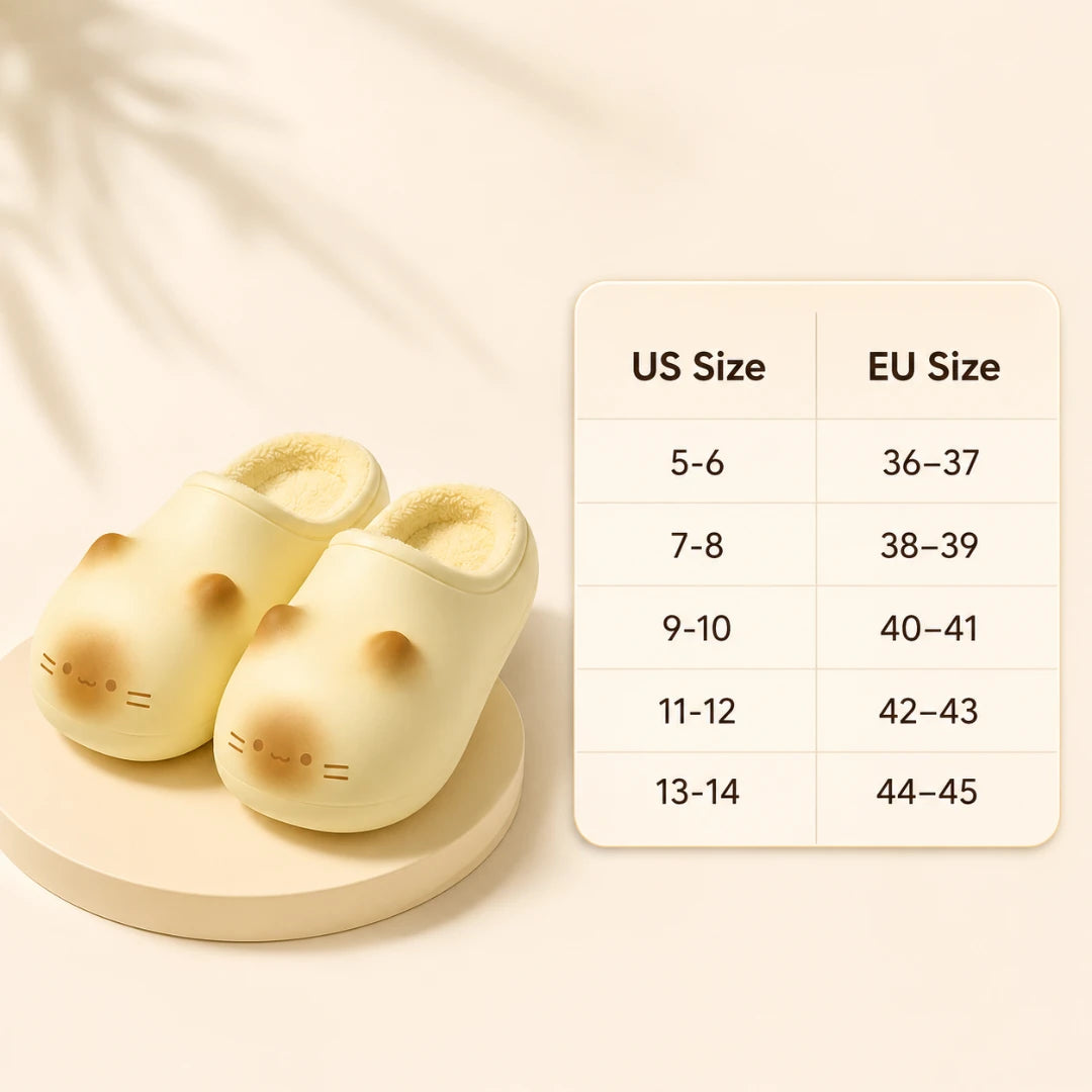 Josh & Tate - PurrPad™ Cozy Cat-Face Slippers - A pair of pale yellow cat-shaped slip-on slippers displayed on a round pedestal next to a size chart comparing US and EU sizes.