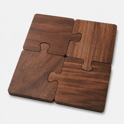 Josh & Tate - PuzzleDeck™ Wood Jigsaw Coasters - Four interlocking square wooden coasters with a dark brown wood grain finish, arranged in a puzzle-like pattern on a light gray background.