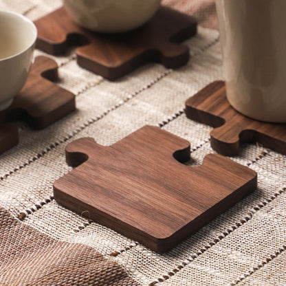 Josh & Tate - PuzzleDeck™ Wood Jigsaw Coasters - Wooden coasters on a textured tablecloth with cups and saucers.