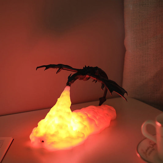 Decorative lamp shaped like a volcano with a scorpion on top, emitting a warm glow.