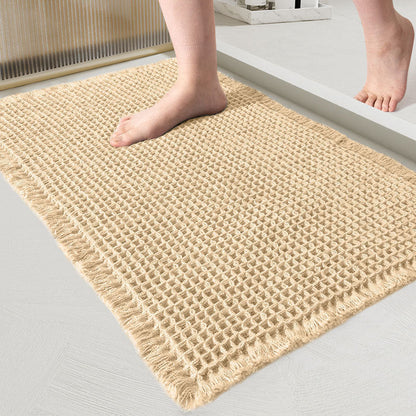 Beige woven mat on a light gray floor with feet stepping onto it.