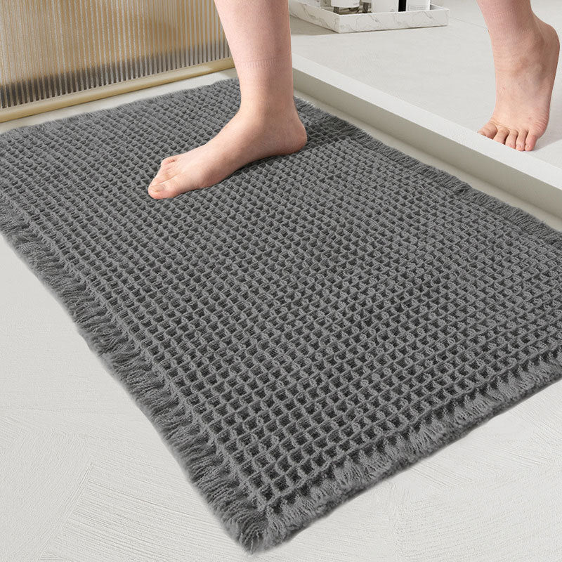 Gray textured bath mat with feet stepping onto it