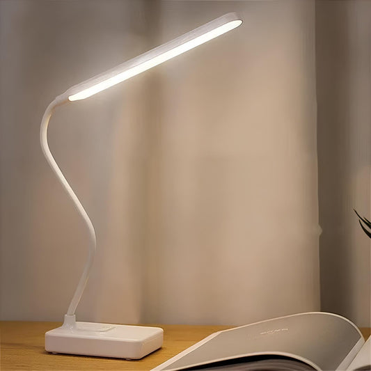 White LED desk lamp on a wooden surface with a blurred background