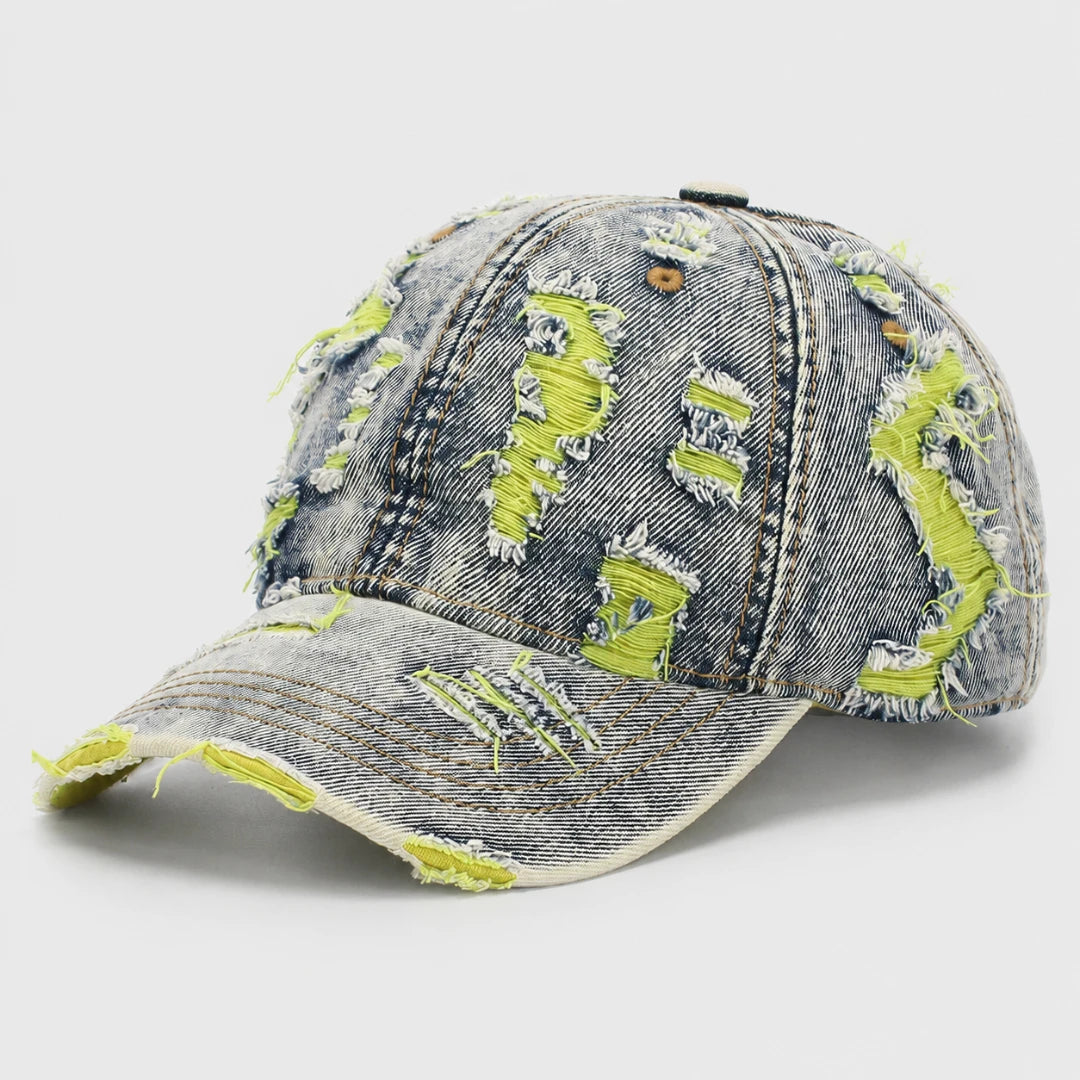 Josh & Tate - RaggedRow™ Distressed Denim Cap - A distressed denim baseball cap with bright neon yellow-green frayed accents, shown on a light gray background.
