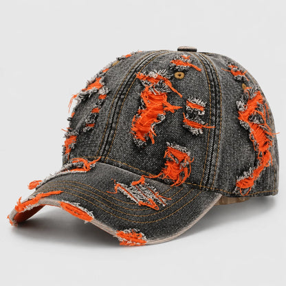 Josh & Tate - RaggedRow™ Distressed Denim Cap - A distressed baseball cap made of dark gray denim with bright orange frayed thread details throughout, shown on a light gray background.