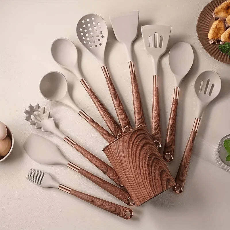 Set of kitchen utensils with wooden handles on a light surface