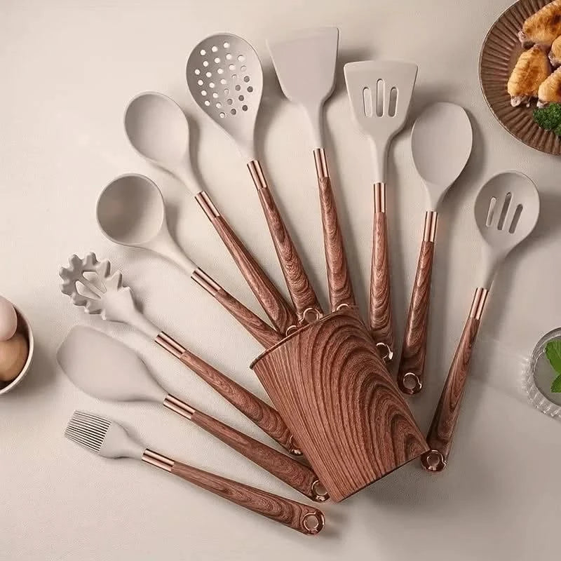 Set of kitchen utensils with wooden handles on a light surface