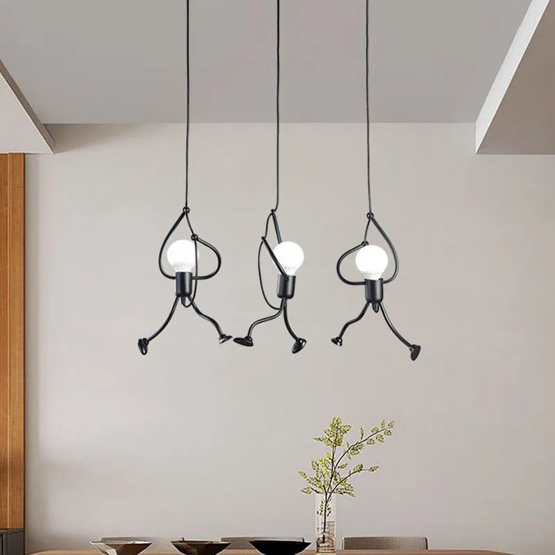 Modern pendant lights hanging above a dining table with a neutral background