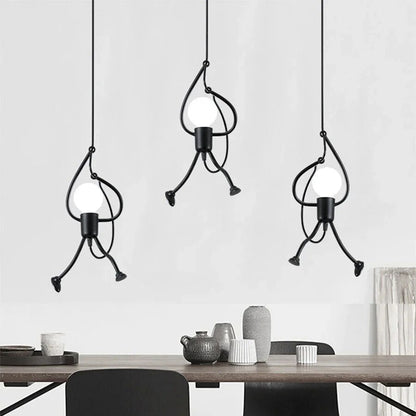 Three modern pendant lights hanging above a dining table with a neutral background
